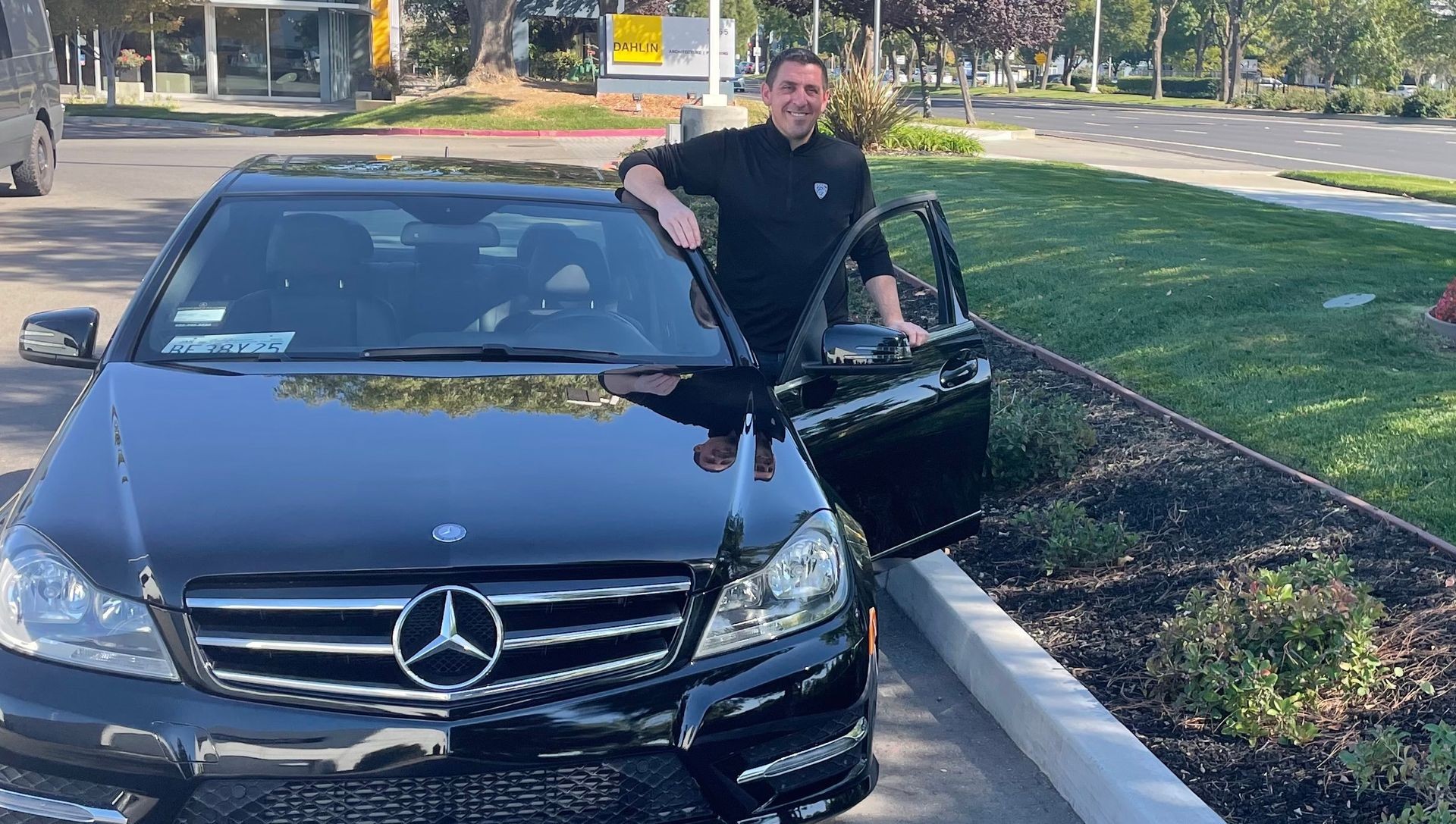 Eagle Star Detail Owner Outside a Black Mercedes Benz after detailing the car